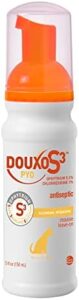 A bottle of Douxo S3 PYO antiseptic mousse for pets, featuring an orange and white design, a pump dispenser, and illustrations indicating its use for cleansing and hydrating.